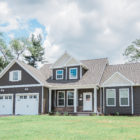 large 1.5 story home with brown siding