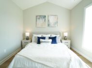 bedroom with blue pillows and art on wall