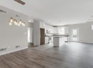 an open layout kitchen with a large island and breakfast bar